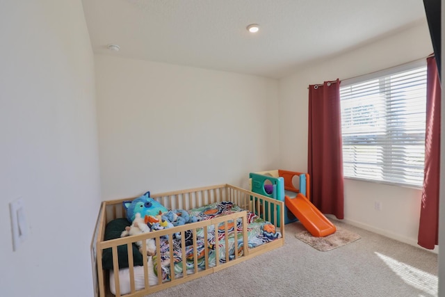 carpeted bedroom featuring multiple windows