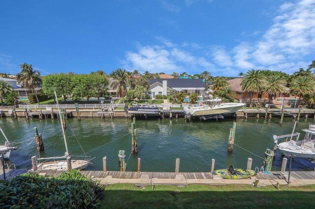 view of dock featuring a water view and a lawn