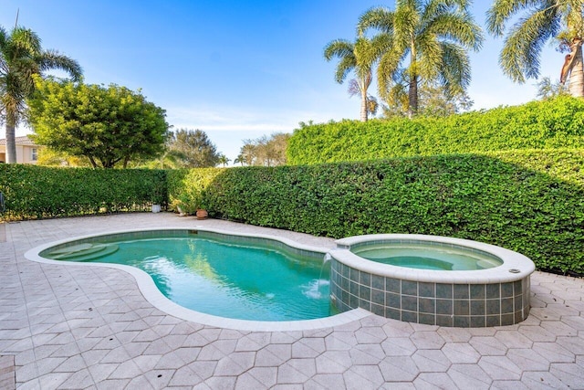 view of swimming pool featuring an in ground hot tub