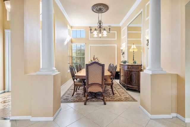 tiled dining space with ornamental molding, a chandelier, and ornate columns