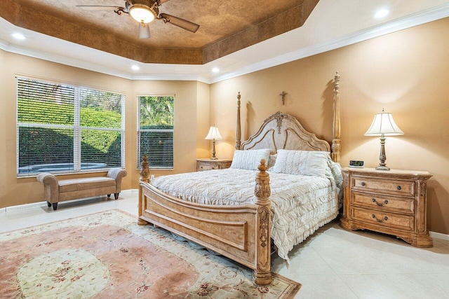 bedroom with ceiling fan, ornamental molding, a raised ceiling, and light tile patterned floors