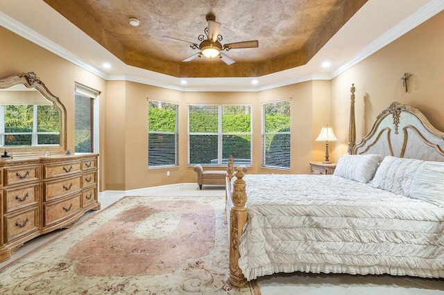 bedroom featuring ceiling fan, ornamental molding, and a raised ceiling