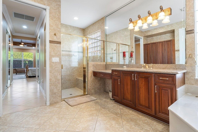 bathroom with ornamental molding, a shower with door, tile patterned flooring, and vanity