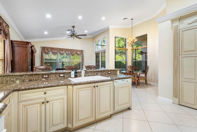 kitchen with pendant lighting, cream cabinets, sink, and dark stone counters