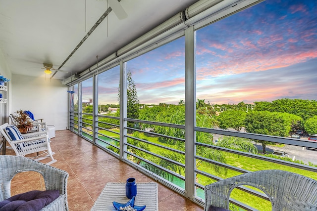 sunroom / solarium featuring ceiling fan