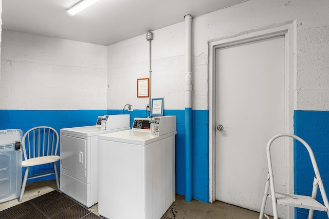 clothes washing area with washer and clothes dryer