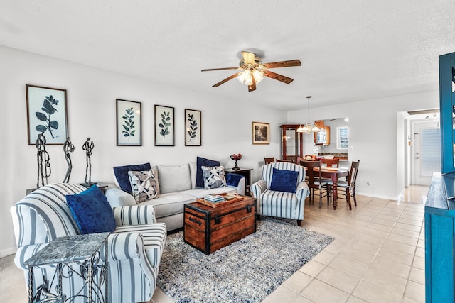 tiled living room with ceiling fan with notable chandelier and a textured ceiling