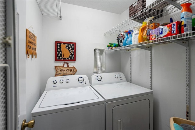 washroom featuring washing machine and clothes dryer