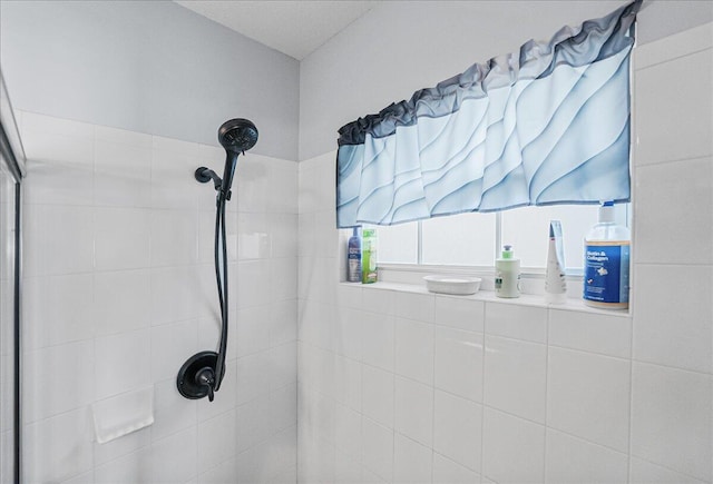 bathroom with a tile shower