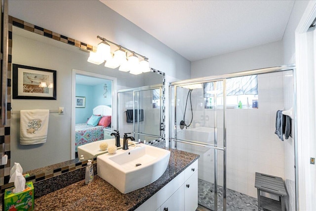 bathroom with vanity and a shower with door