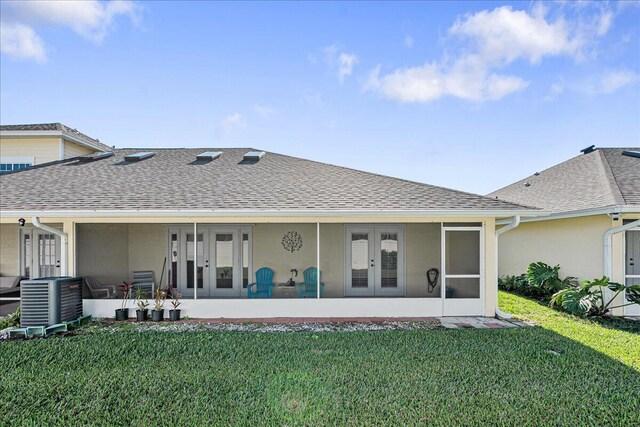 back of property with cooling unit, a yard, a patio, and french doors