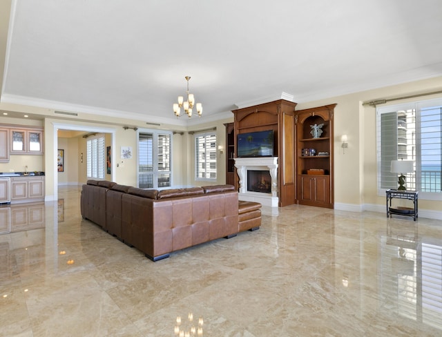 living room with a notable chandelier and ornamental molding