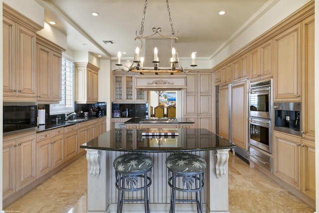 kitchen featuring light brown cabinetry, decorative backsplash, a center island, and a chandelier