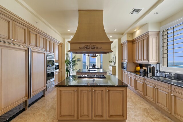 kitchen featuring sink, a center island, dark stone countertops, and custom exhaust hood