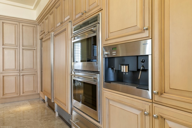 kitchen with double oven and light brown cabinetry