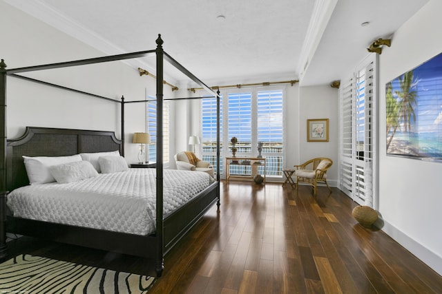 bedroom featuring expansive windows, crown molding, and dark wood-type flooring