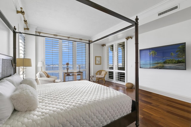 bedroom featuring dark hardwood / wood-style floors and crown molding