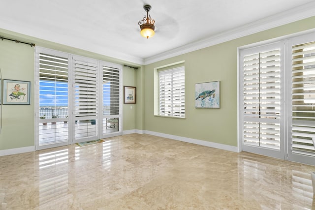 empty room with ceiling fan and crown molding