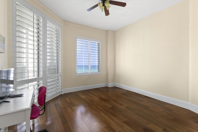 unfurnished office featuring ceiling fan and dark hardwood / wood-style floors