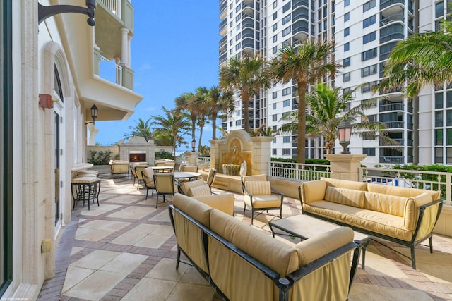 view of patio featuring an outdoor living space with a fireplace