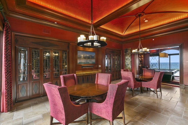 dining space featuring a chandelier and crown molding