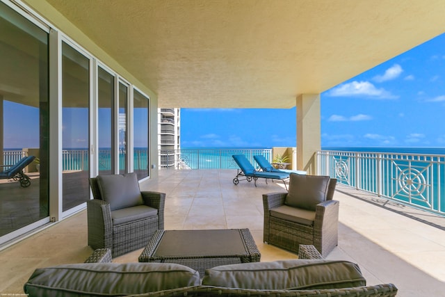 view of patio / terrace featuring a water view and a balcony