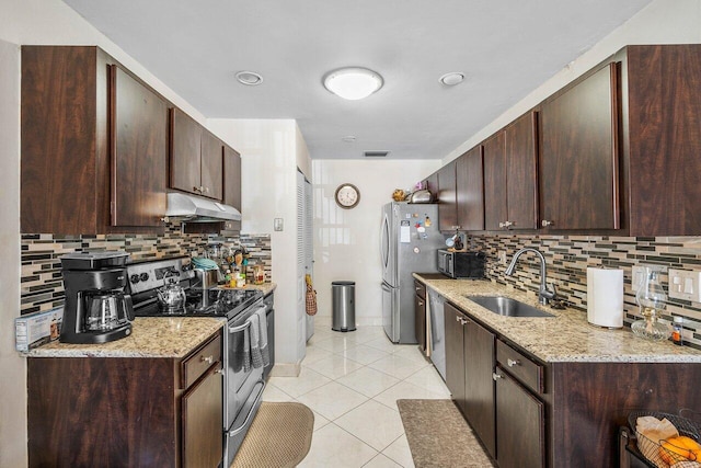 kitchen with appliances with stainless steel finishes, backsplash, light tile patterned floors, and sink