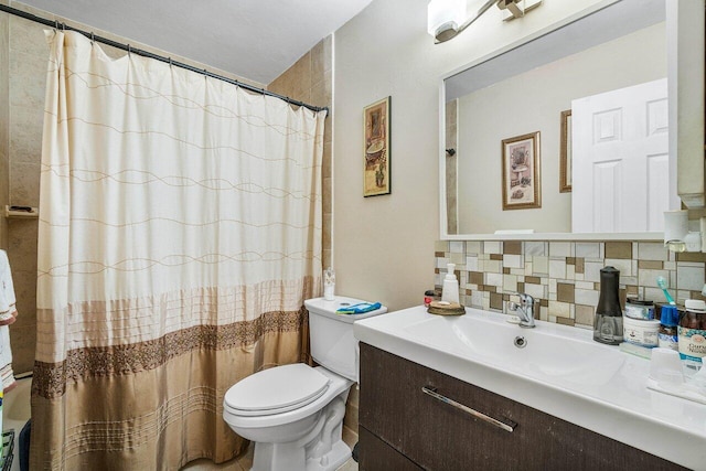 bathroom featuring vanity, backsplash, and toilet