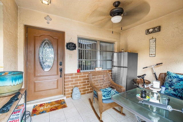 entrance to property featuring ceiling fan and covered porch