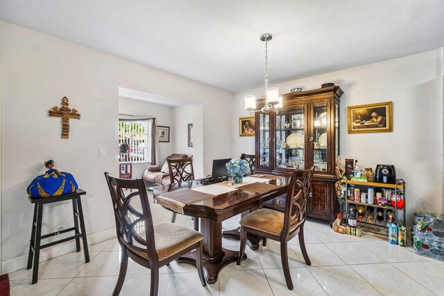 tiled dining space featuring a notable chandelier