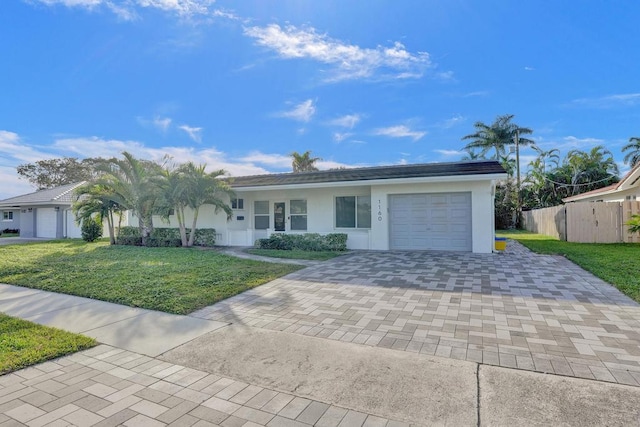 single story home featuring a front yard and a garage