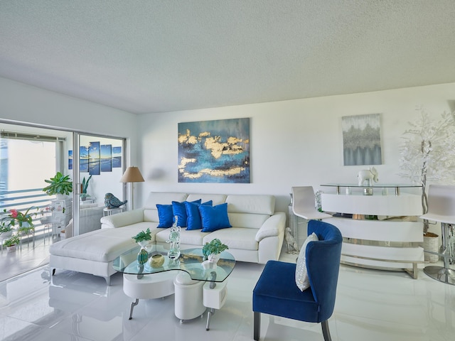 tiled living room featuring a textured ceiling