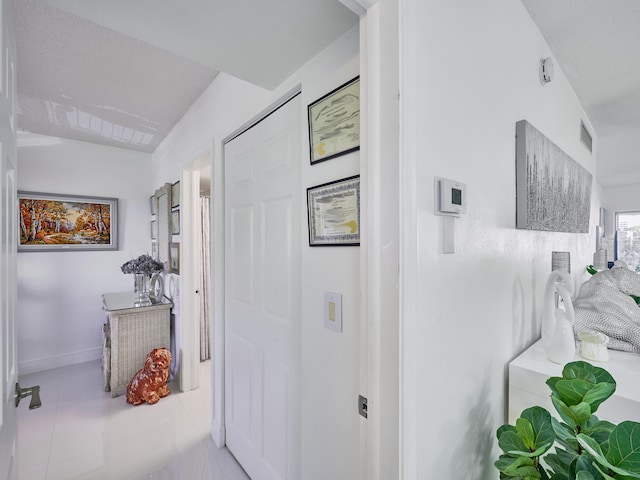 corridor with light tile patterned floors