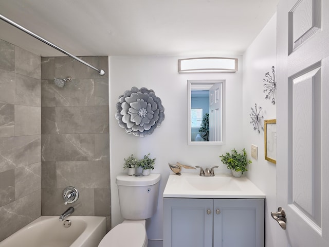 full bathroom with vanity, toilet, and tiled shower / bath