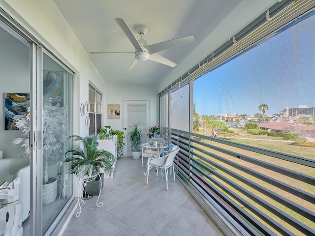 sunroom / solarium featuring ceiling fan