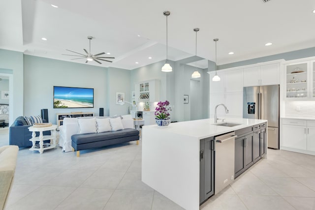 kitchen featuring appliances with stainless steel finishes, decorative light fixtures, white cabinetry, and sink