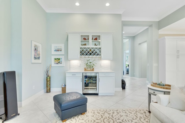 bar with white cabinets, decorative backsplash, beverage cooler, and light tile patterned flooring