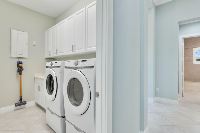 laundry area with cabinets, light tile patterned floors, and washer and dryer