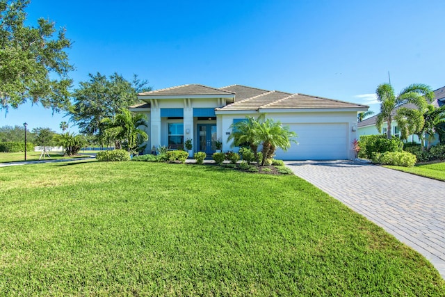 view of front of house with a garage and a front lawn