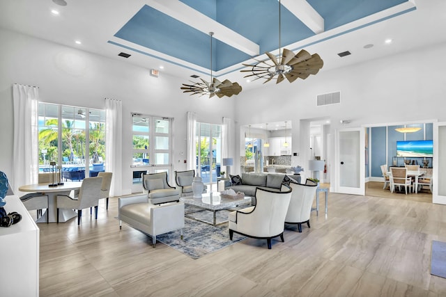 living room featuring french doors, a towering ceiling, and ceiling fan