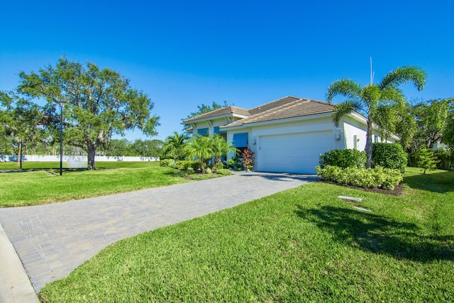 view of front facade featuring a garage and a front lawn