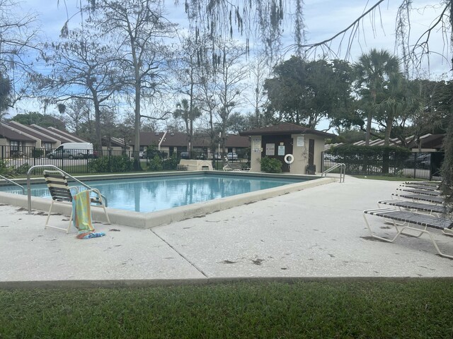 view of pool featuring a lawn