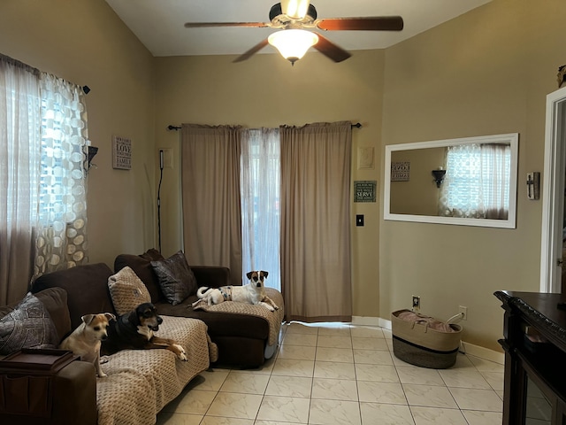 living room featuring light tile patterned flooring, ceiling fan, and baseboards