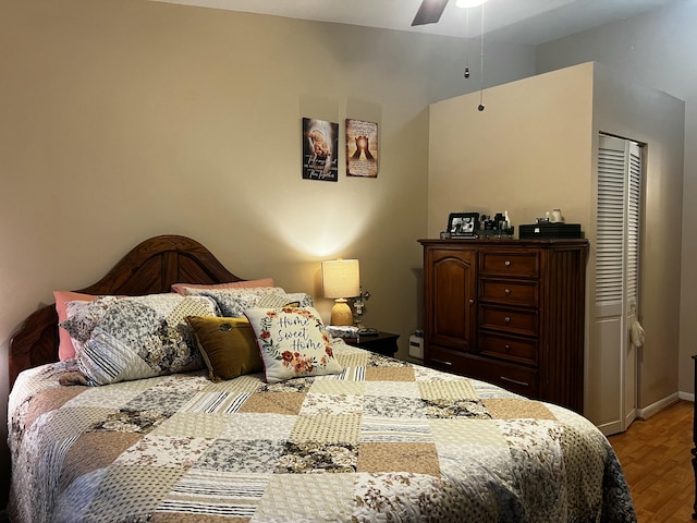 bedroom featuring ceiling fan, hardwood / wood-style floors, and a closet