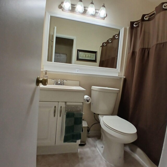 bathroom featuring vanity, tile patterned floors, and toilet