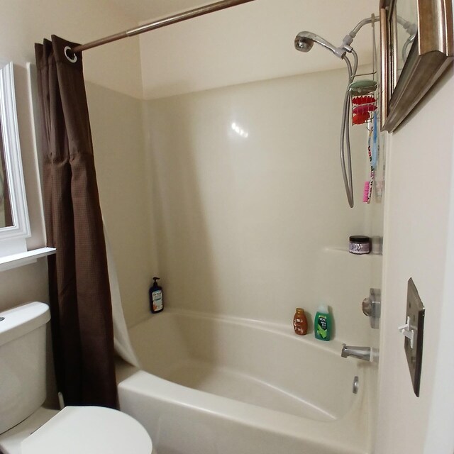 bathroom featuring toilet and a shower with shower curtain