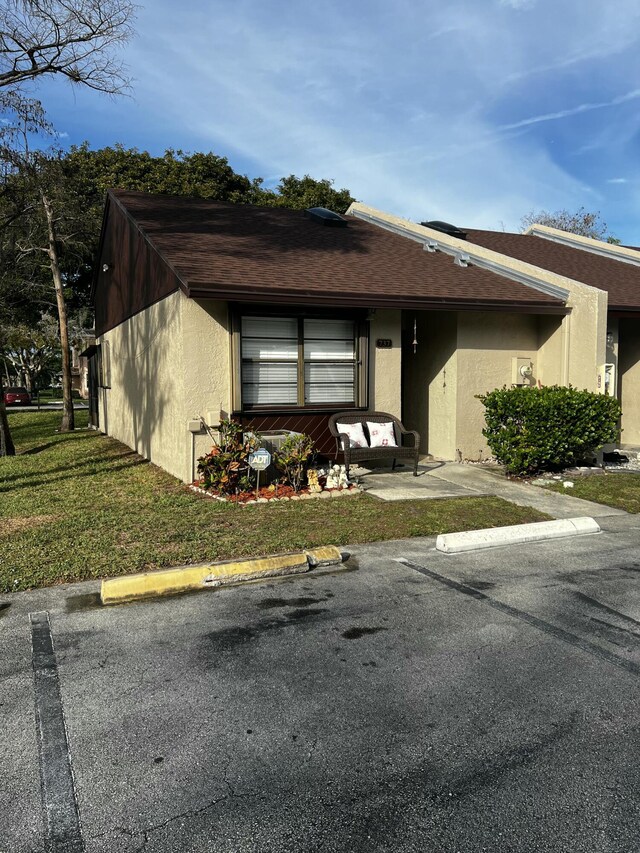 view of side of property featuring a sunroom and a lawn