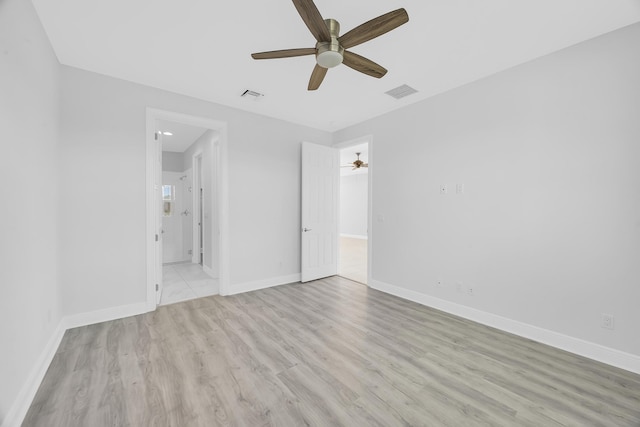 empty room featuring ceiling fan and light wood-type flooring