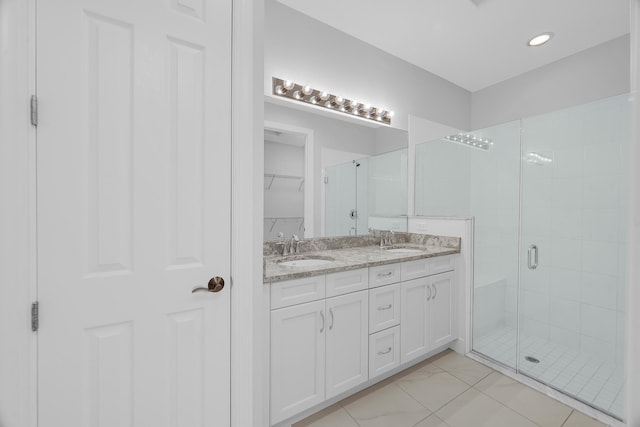 bathroom with a shower with door and vanity