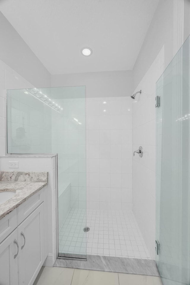 bathroom featuring vanity and a shower with shower door